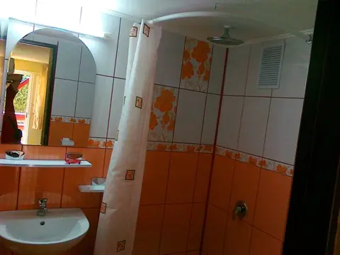 Baie cu duș și faianță portocalie
