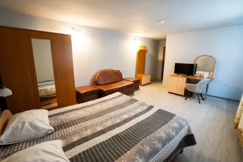 Cameră de hotel cu pat dublu, televizor și fotoliu